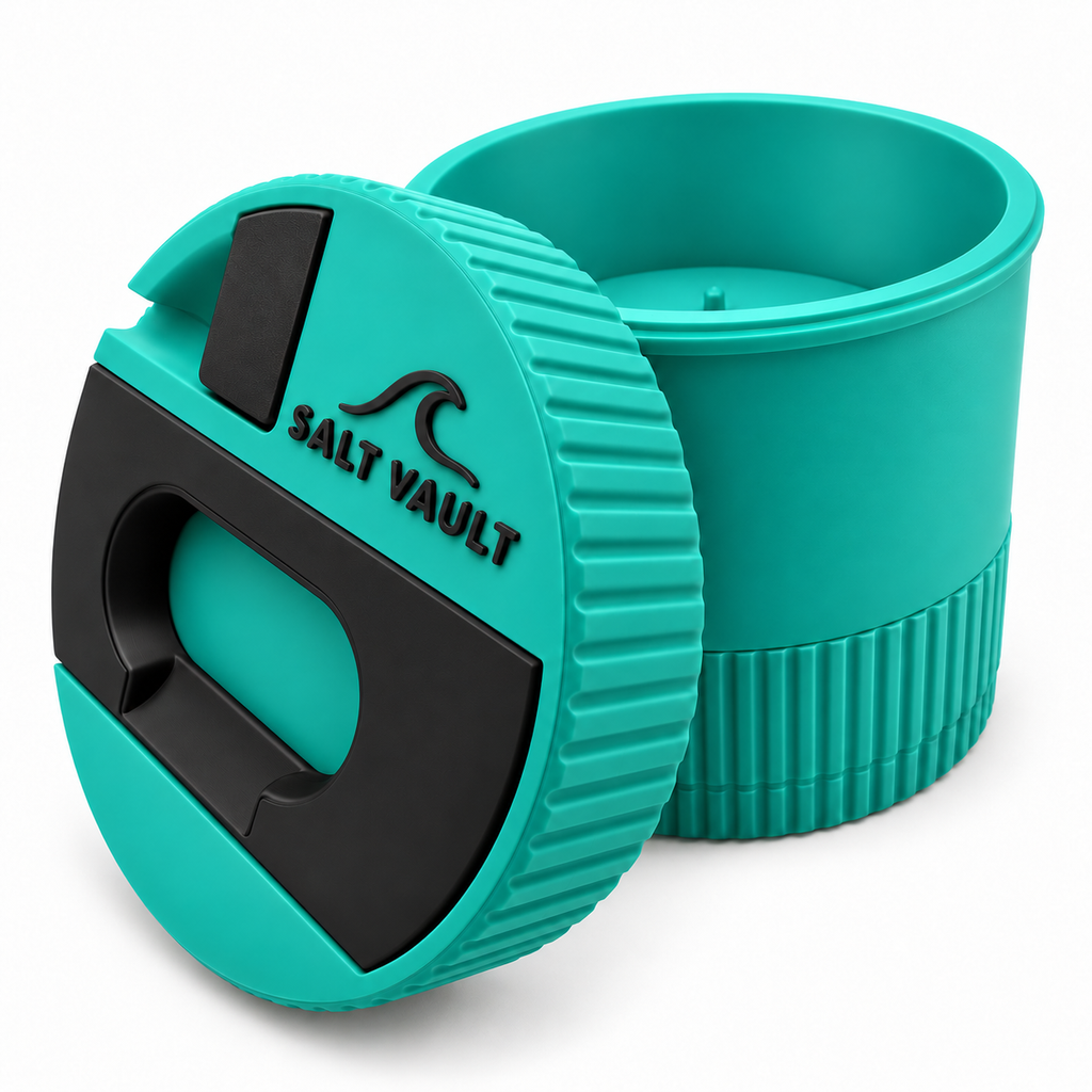Salt Vault in Reef Teal with the lid tilted beside the open tub, showing the ribbed grip edge and wind-up base
