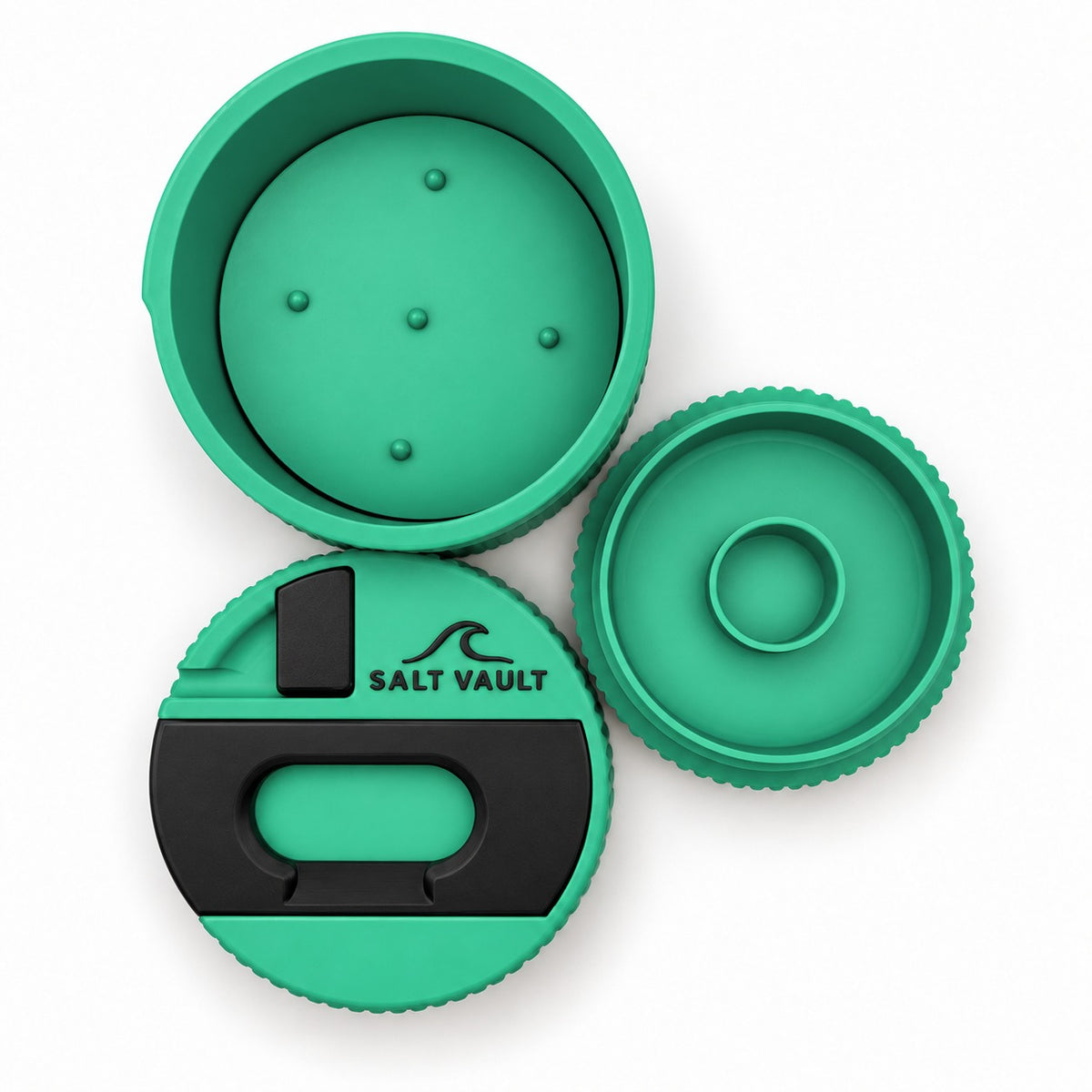 Salt Vault in Sea Green taken apart, top-down: the tub with its wax pusher plate, the lid with scraper and opener, and the base with its zinc compartment